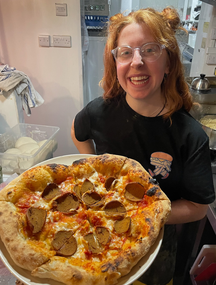 sous chef amber with a freshly cooked vegan pizza at our restaurant in paignton